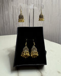 Zarreen antique gold jaali jhumka earrings on an acrylic stand and in a black gift box