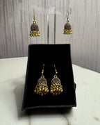 Zarreen antique gold jaali jhumka earrings on an acrylic stand and in a black gift box